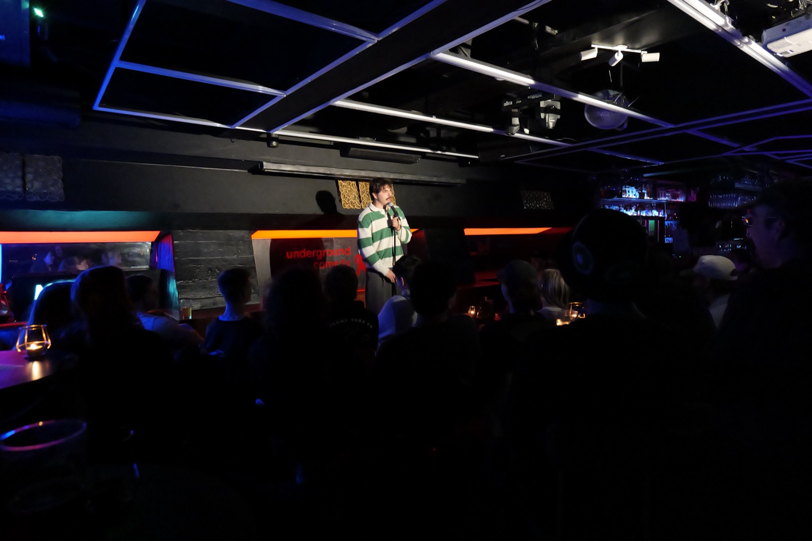 A comedian performing on stage at Melbourne Comedy Club